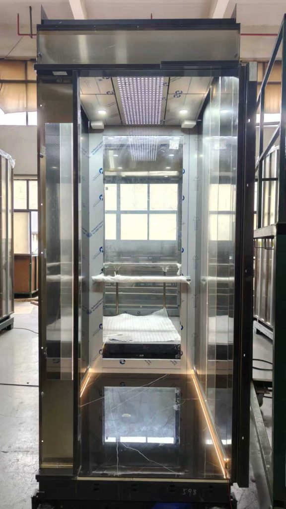 Modern glass-sided Nexco elevator cabin