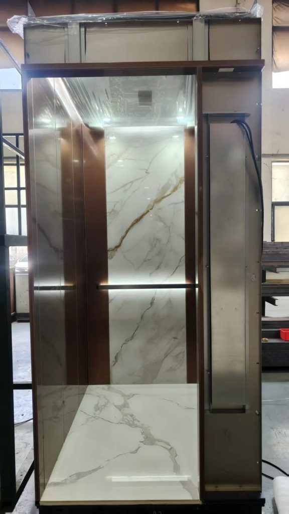 Nexco elevator cabin with marble back panel and warm trim