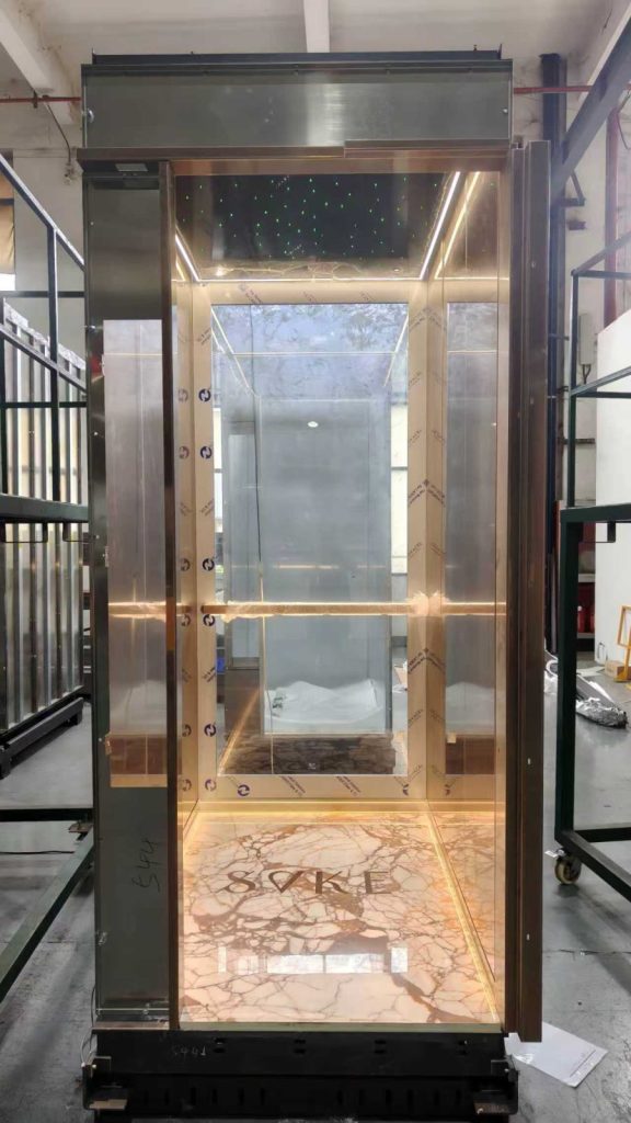 Gold-finish Nexco elevator cabin with starlight ceiling