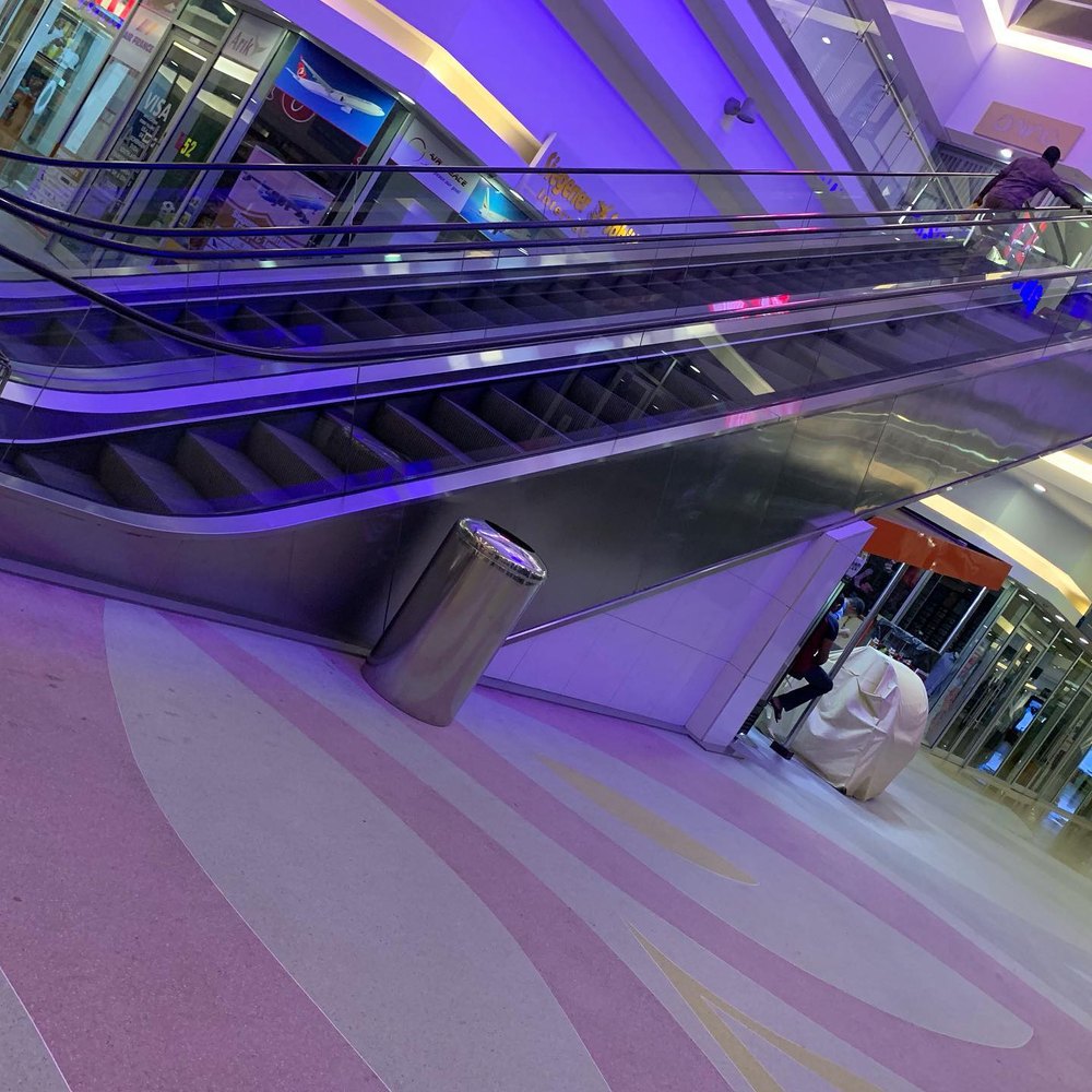 Escalator installed by Nexco in a lit concourse
